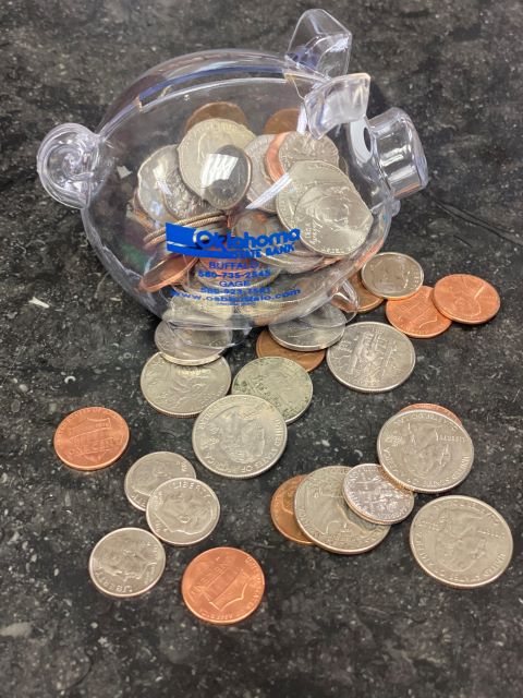 piggy bank with change on counter